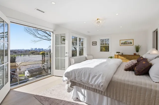 a bedroom with a large bed and a large window