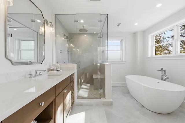 a bathroom with a double vanity sink mirror double and shower