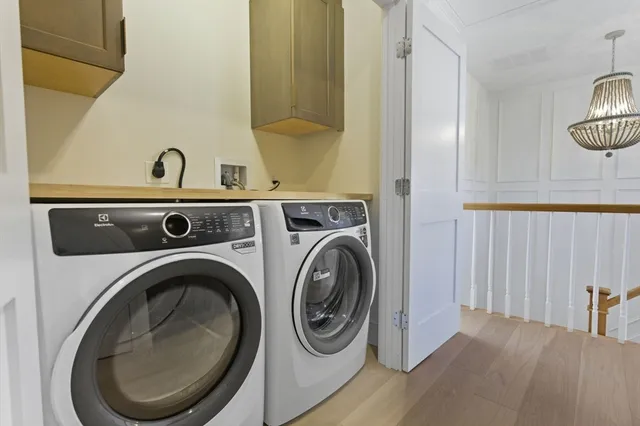 a utility room with sink dryer and washer