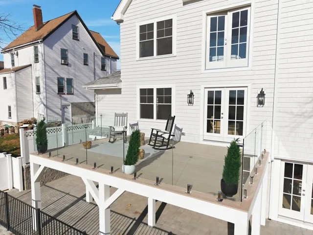 a view of a house with backyard and sitting area