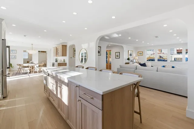 a large white kitchen with a large window
