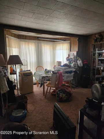 a living room with furniture a rug and a window