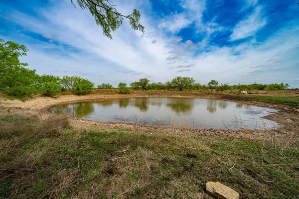 a view of a lake with houses in the back