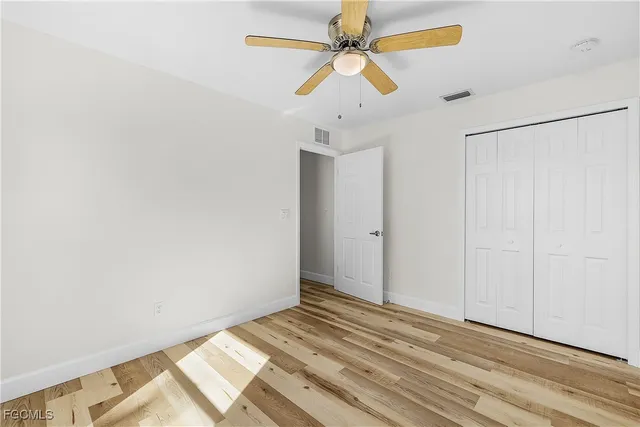a view of a room with a ceiling fan