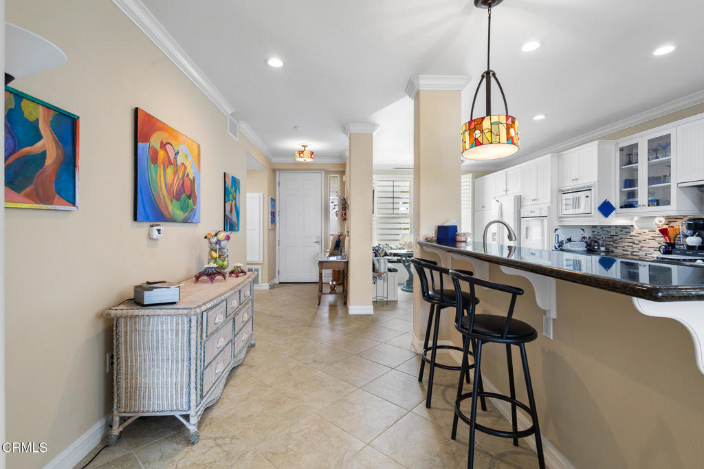 1547 Windshore Way Oxnard, CA 93035 - Photo 11 of 33 a kitchen with stainless steel appliances kitchen island granite countertop a table and chairs in it