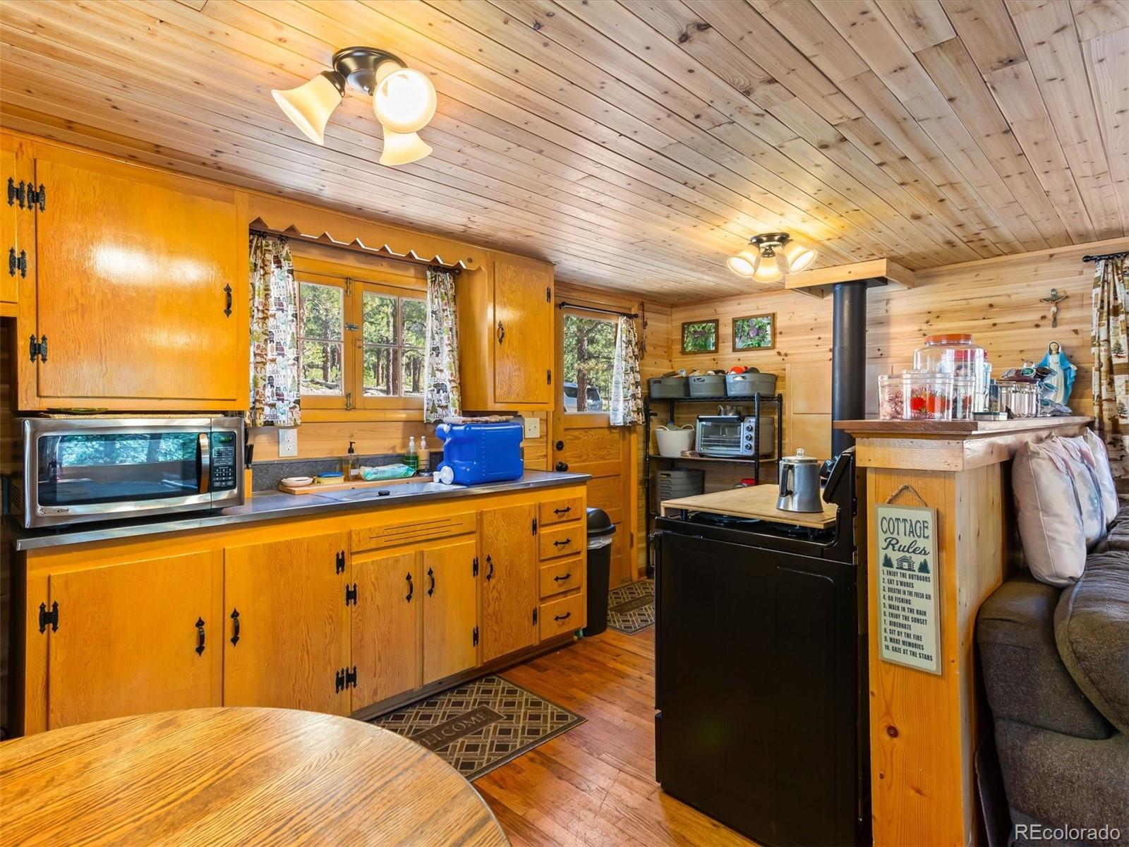 P69 P 69 Bailey, CO 80421 - Photo 11 of 22 a kitchen with stainless steel appliances kitchen island granite countertop a table chairs in it and wooden floor