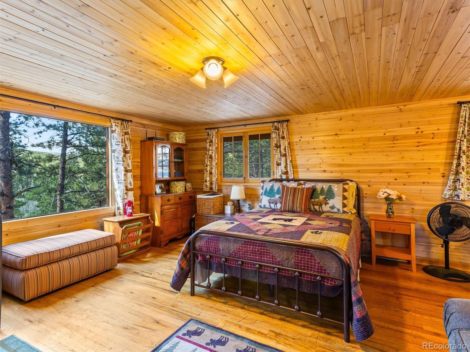 P69 P 69 Bailey, CO 80421 - Photo 7 of 22 a bedroom with a bed and wooden floor