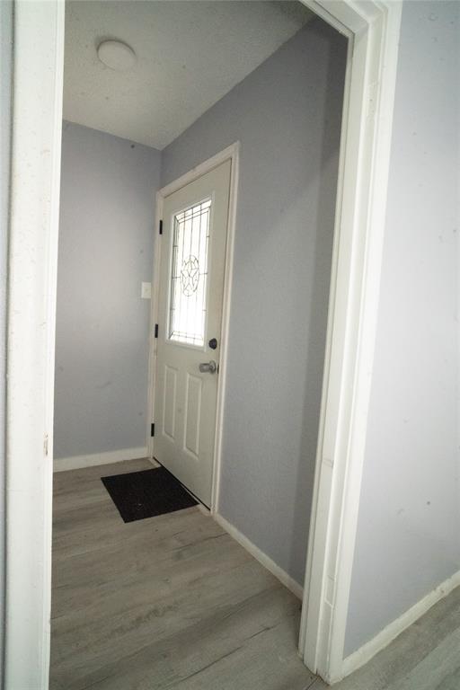2136 Ridgeway Street Arlington, TX 76010 - Photo 6 of 32 an empty room with wooden floor and windows