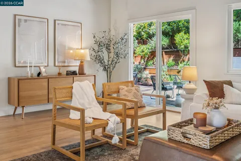 a living room with fireplace furniture and a large window