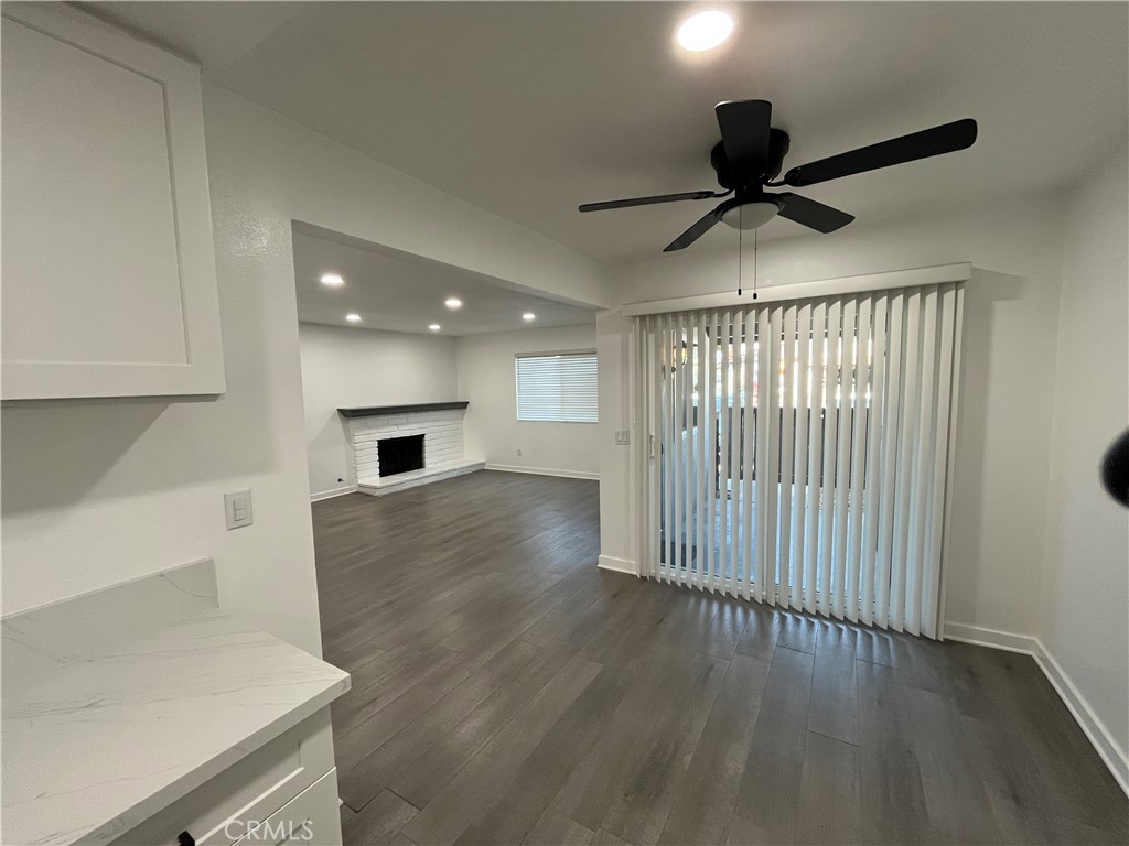 9155 Pacific Avenue, Unit 219 Anaheim, CA 92804 - Photo 1 of 26 a view of an empty room with wooden floor and a window