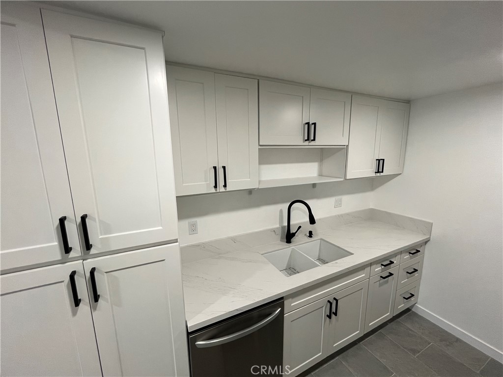 9155 Pacific Avenue, Unit 219 Anaheim, CA 92804 - Photo 13 of 26 a kitchen with a sink and a refrigerator