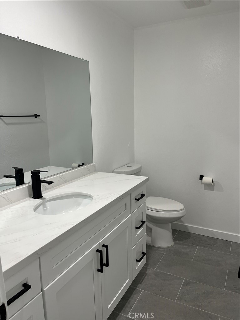9155 Pacific Avenue, Unit 219 Anaheim, CA 92804 - Photo 15 of 26 a bathroom with a sink a toilet and a mirror