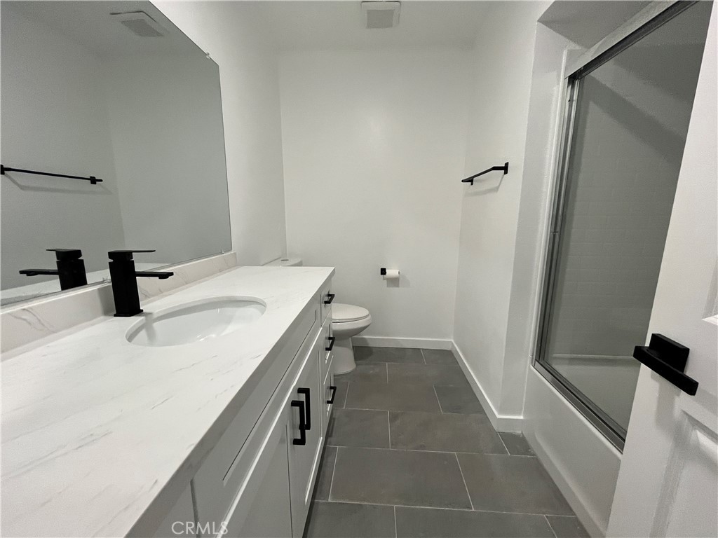 9155 Pacific Avenue, Unit 219 Anaheim, CA 92804 - Photo 17 of 26 a bathroom with a sink toilet and shower