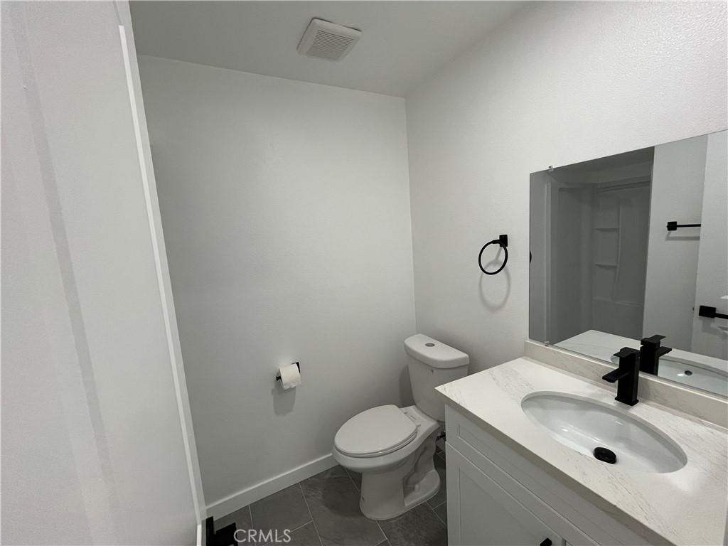 9155 Pacific Avenue, Unit 219 Anaheim, CA 92804 - Photo 21 of 26 a bathroom with a sink toilet and mirror