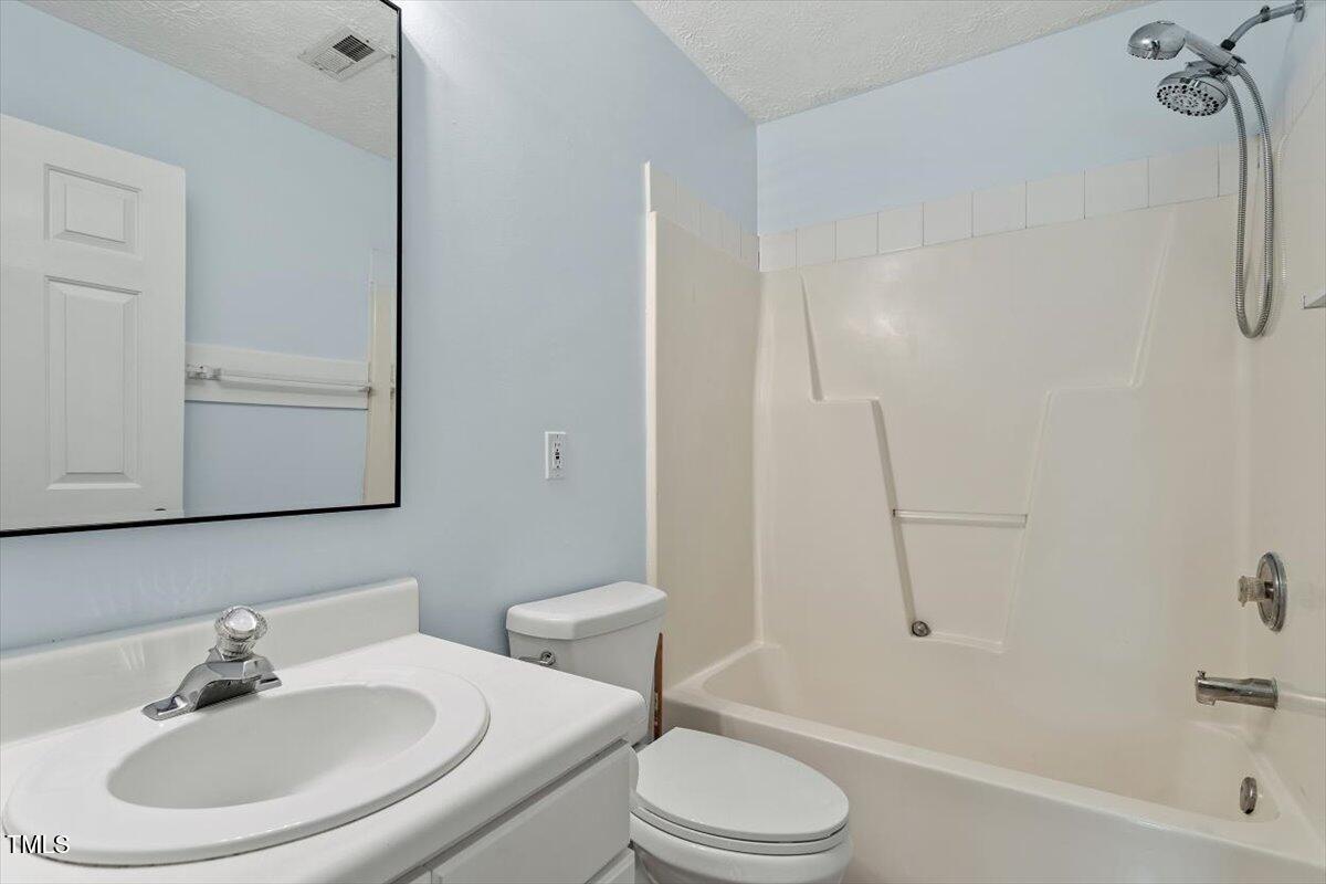 2733 Midway Park Court Raleigh, NC 27610 - Photo 24 of 30 a bathroom with a sink a toilet and a bathtub