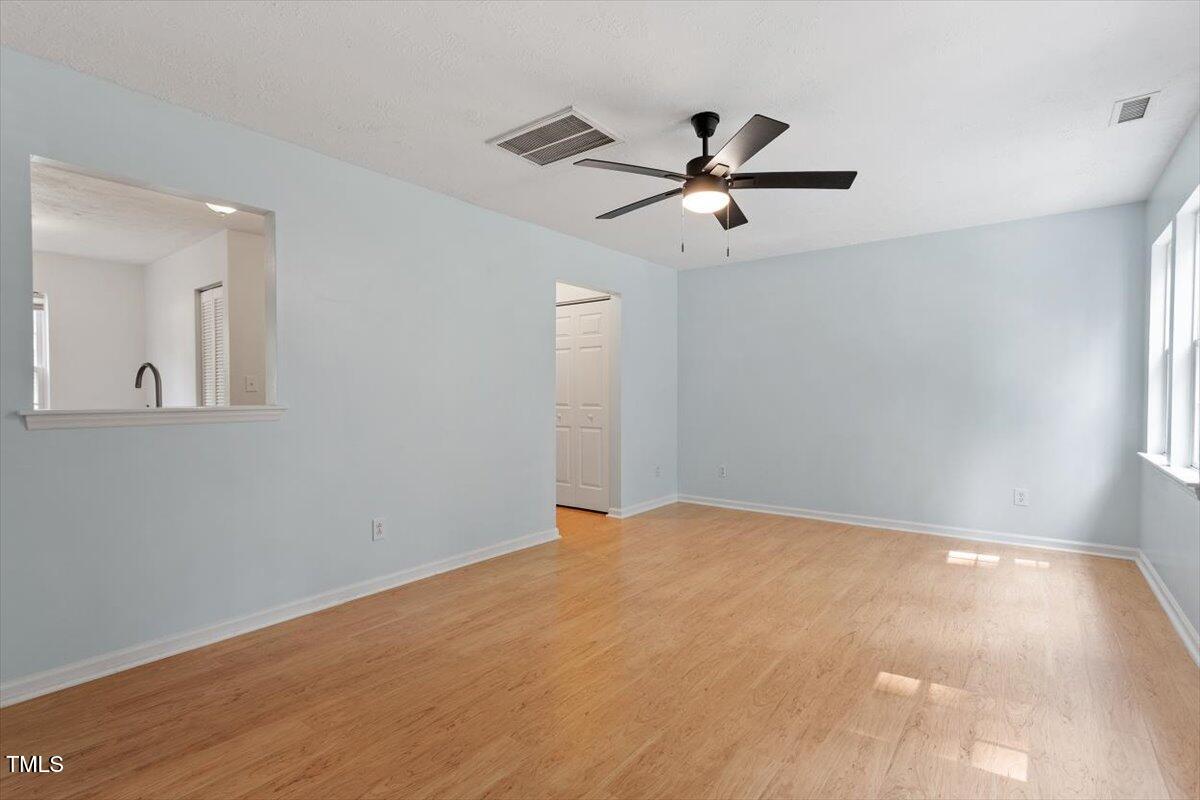 2733 Midway Park Court Raleigh, NC 27610 - Photo 8 of 30 a view of a big room with wooden floor closet and windows