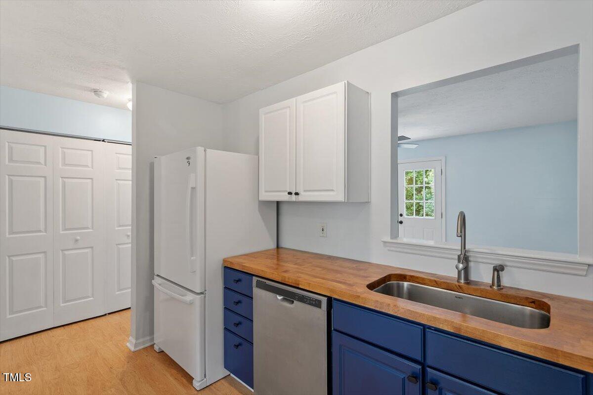2733 Midway Park Court Raleigh, NC 27610 - Photo 10 of 30 a kitchen with a sink cabinets and a window