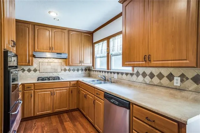 a kitchen with a sink a window and cabinets