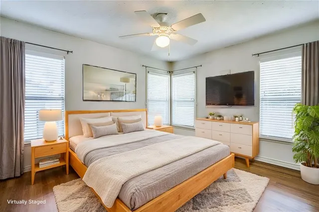 a bedroom with a bed a flat screen tv and a couch