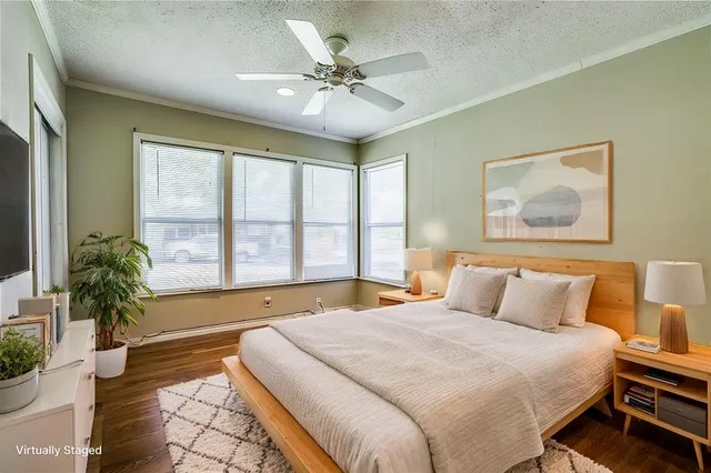 a spacious bedroom with a large bed and a large window