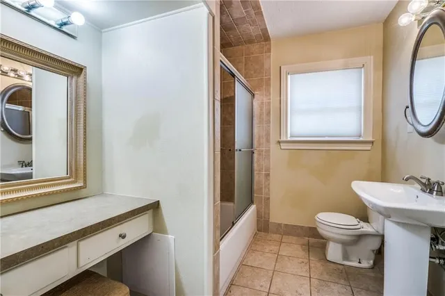 a bathroom with a toilet a sink and a mirror