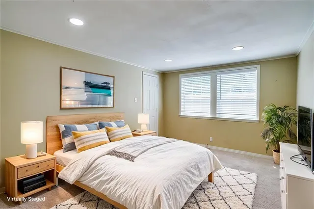 a bedroom with a bed and a potted plant