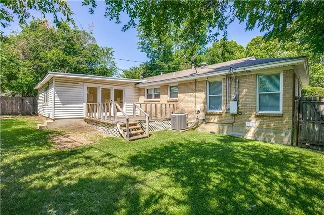 a backyard of a house with garden and barbeque oven