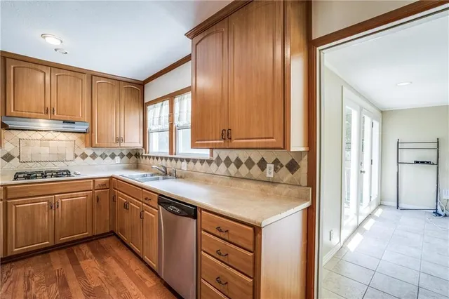 a kitchen with a sink stove and cabinets