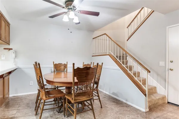 a view of a dining room with furniture and a chandelier