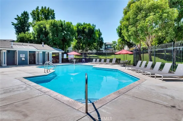 a view of a house with swimming pool and sitting area