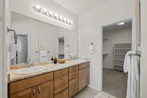 a bathroom with a double vanity sink and a mirror