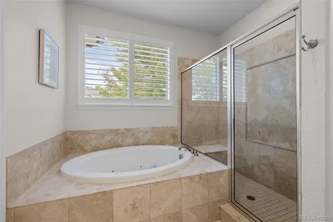 a bathroom with a bathtub and shower