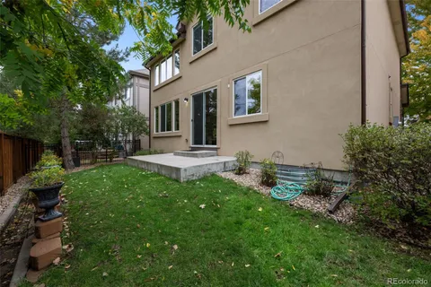 a front view of a house with garden and sitting area