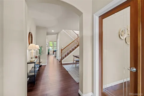a view of entryway and hall with wooden floor