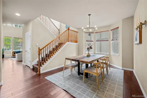 a dining room with furniture window and wooden floor