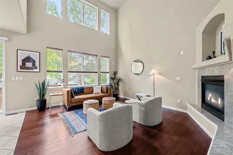a living room with furniture fireplace and window