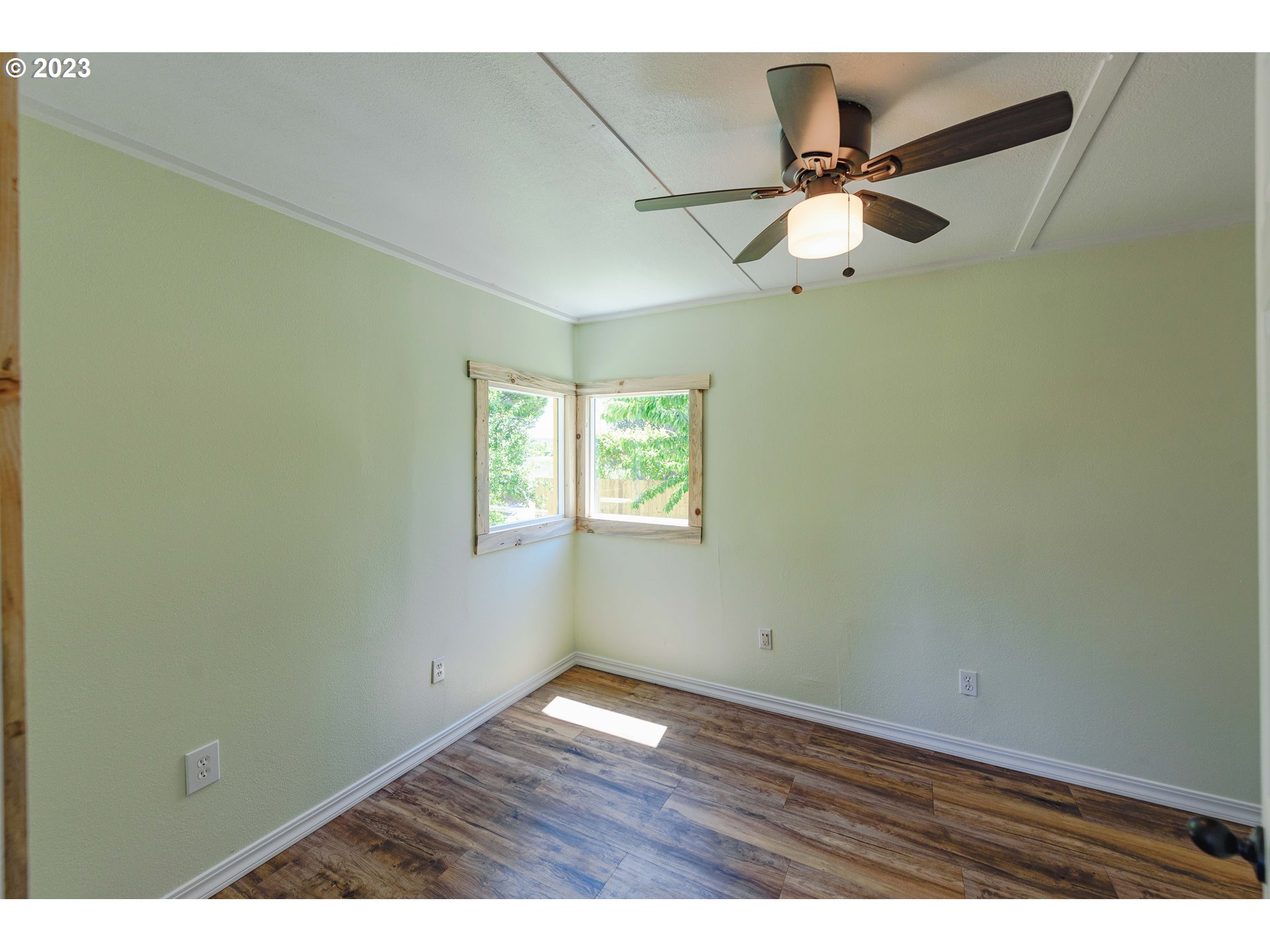 54156 Old Broadbent Road Myrtle Point, OR 97458 - Photo 13 of 48 an empty room with wooden floor and fan