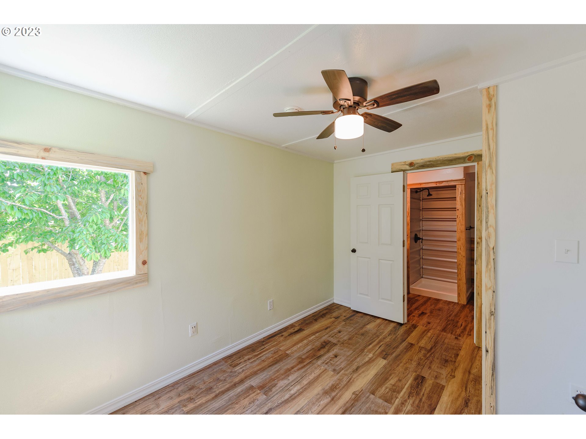 54156 Old Broadbent Road Myrtle Point, OR 97458 - Photo 16 of 48 a view of an empty room with wooden floor and a window