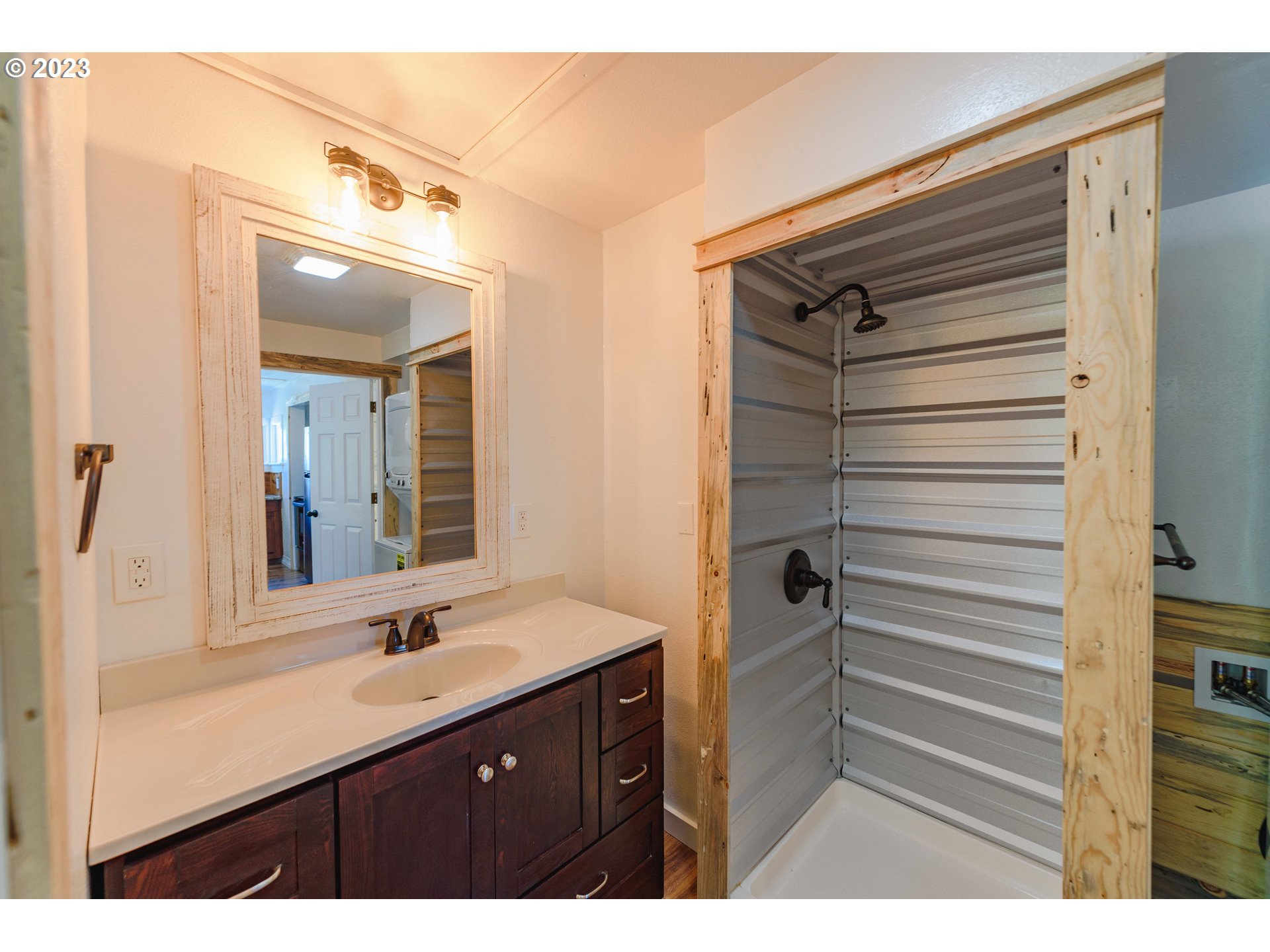 54156 Old Broadbent Road Myrtle Point, OR 97458 - Photo 21 of 48 a bathroom with a sink a mirror and shower