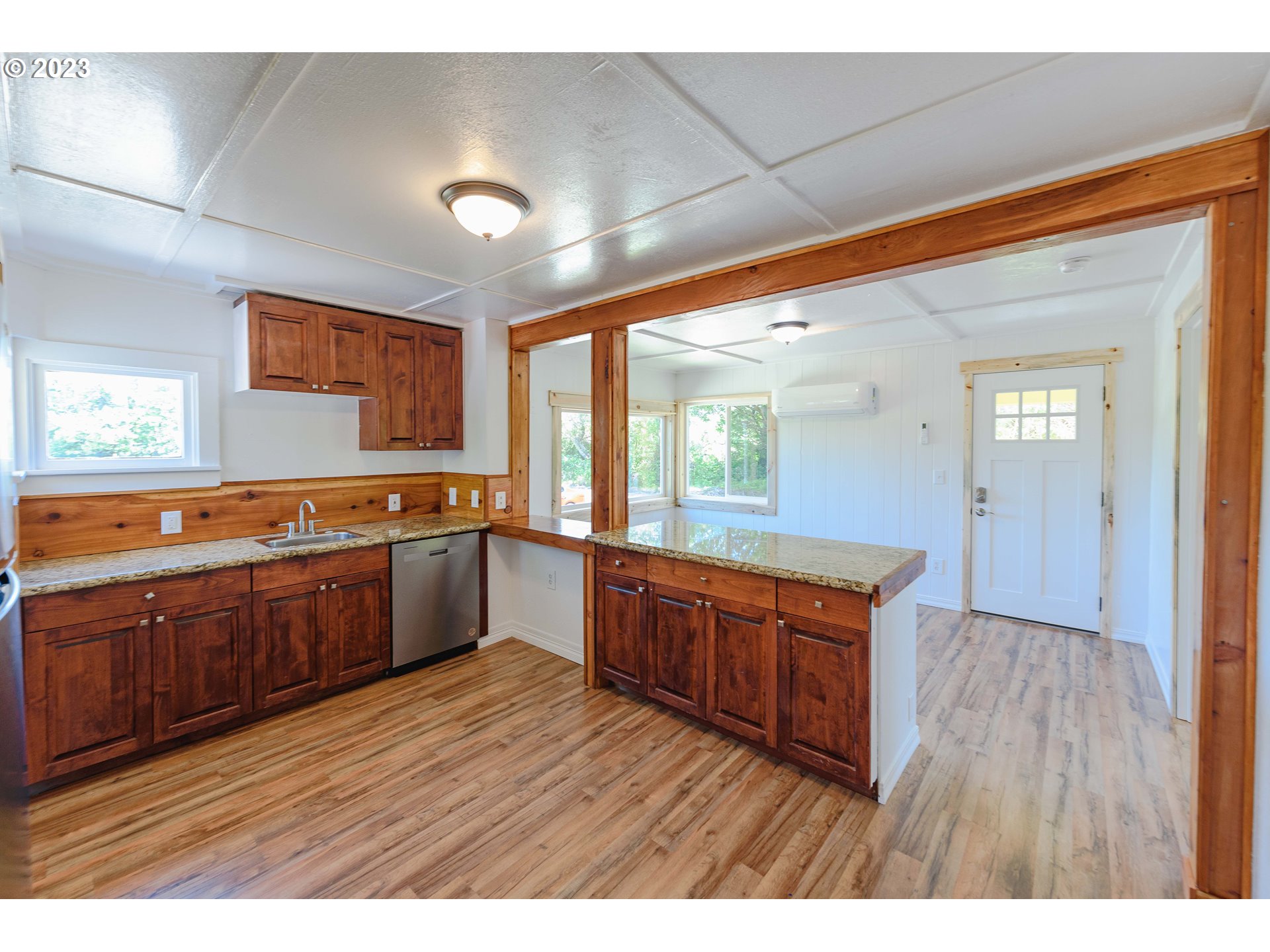 54156 Old Broadbent Road Myrtle Point, OR 97458 - Photo 22 of 48 a large kitchen with wooden floors and wooden cabinets