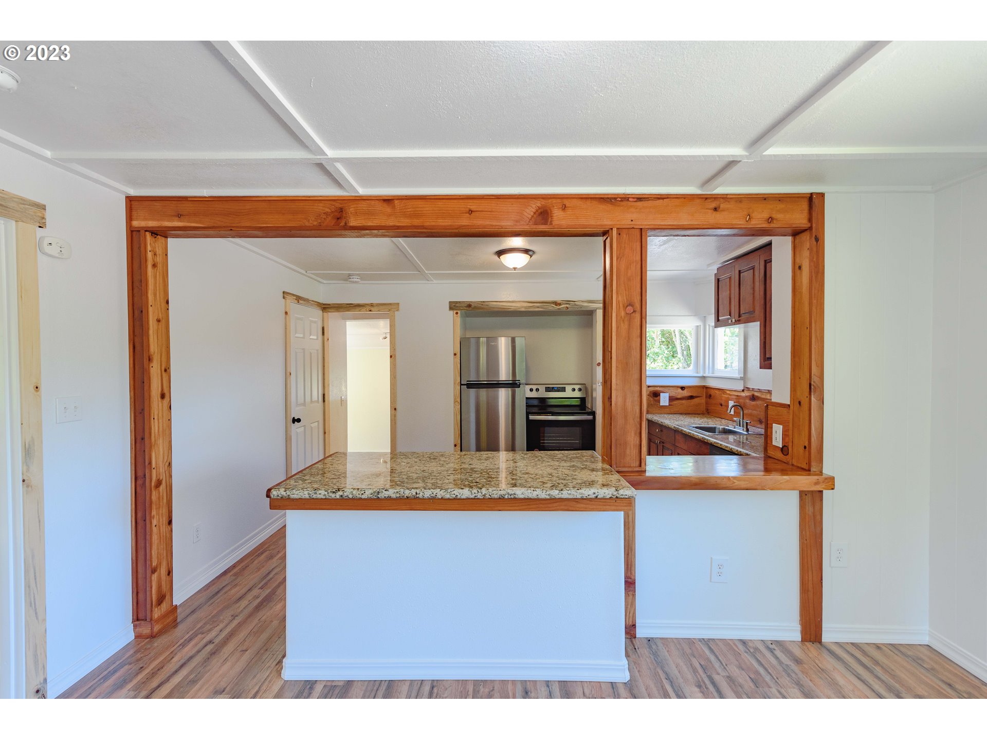 54156 Old Broadbent Road Myrtle Point, OR 97458 - Photo 24 of 48 a view of kitchen with kitchen island granite countertop a sink and dishwasher with wooden floor