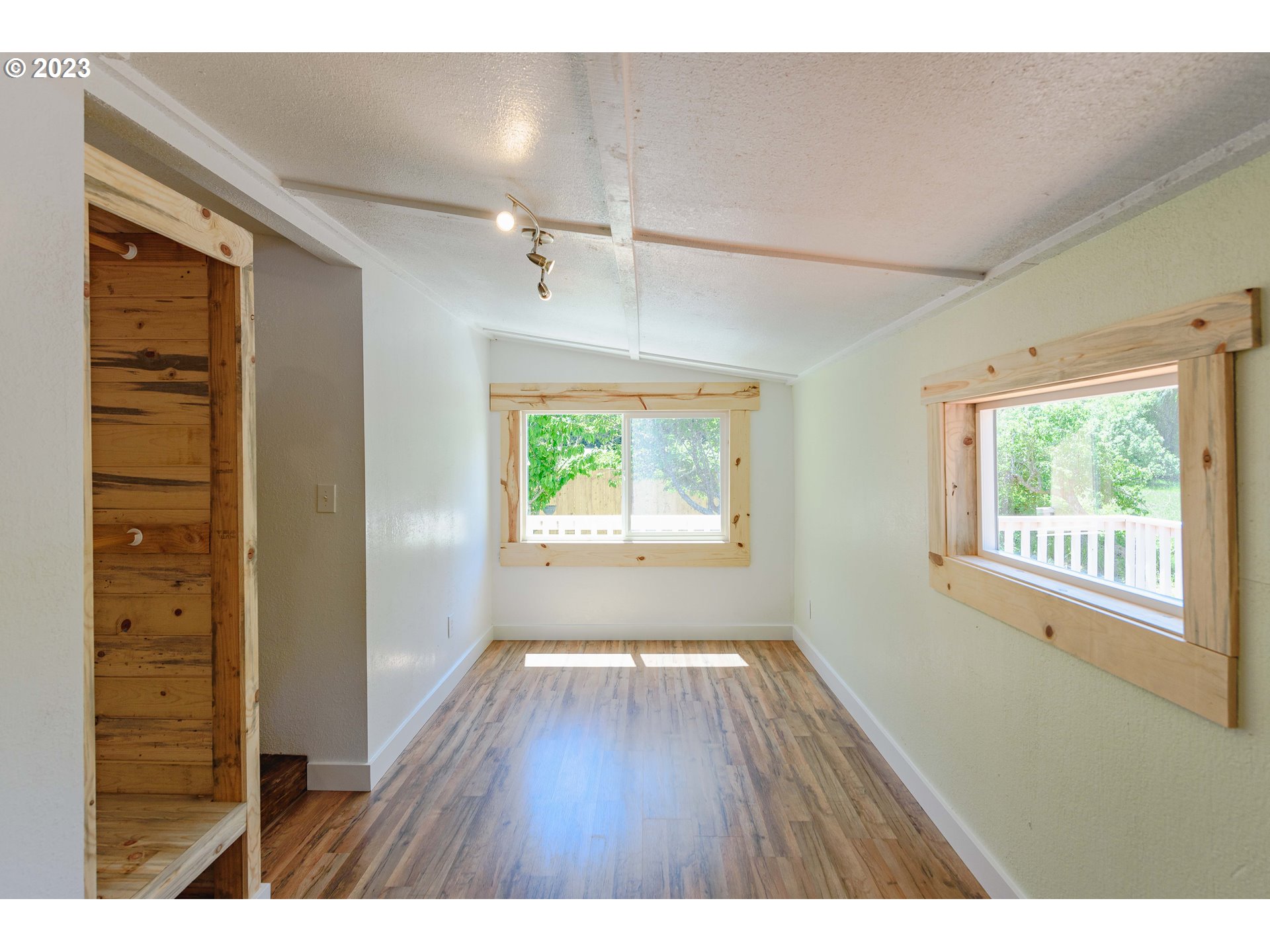 54156 Old Broadbent Road Myrtle Point, OR 97458 - Photo 6 of 48 a view of an empty room with wooden floor and a window