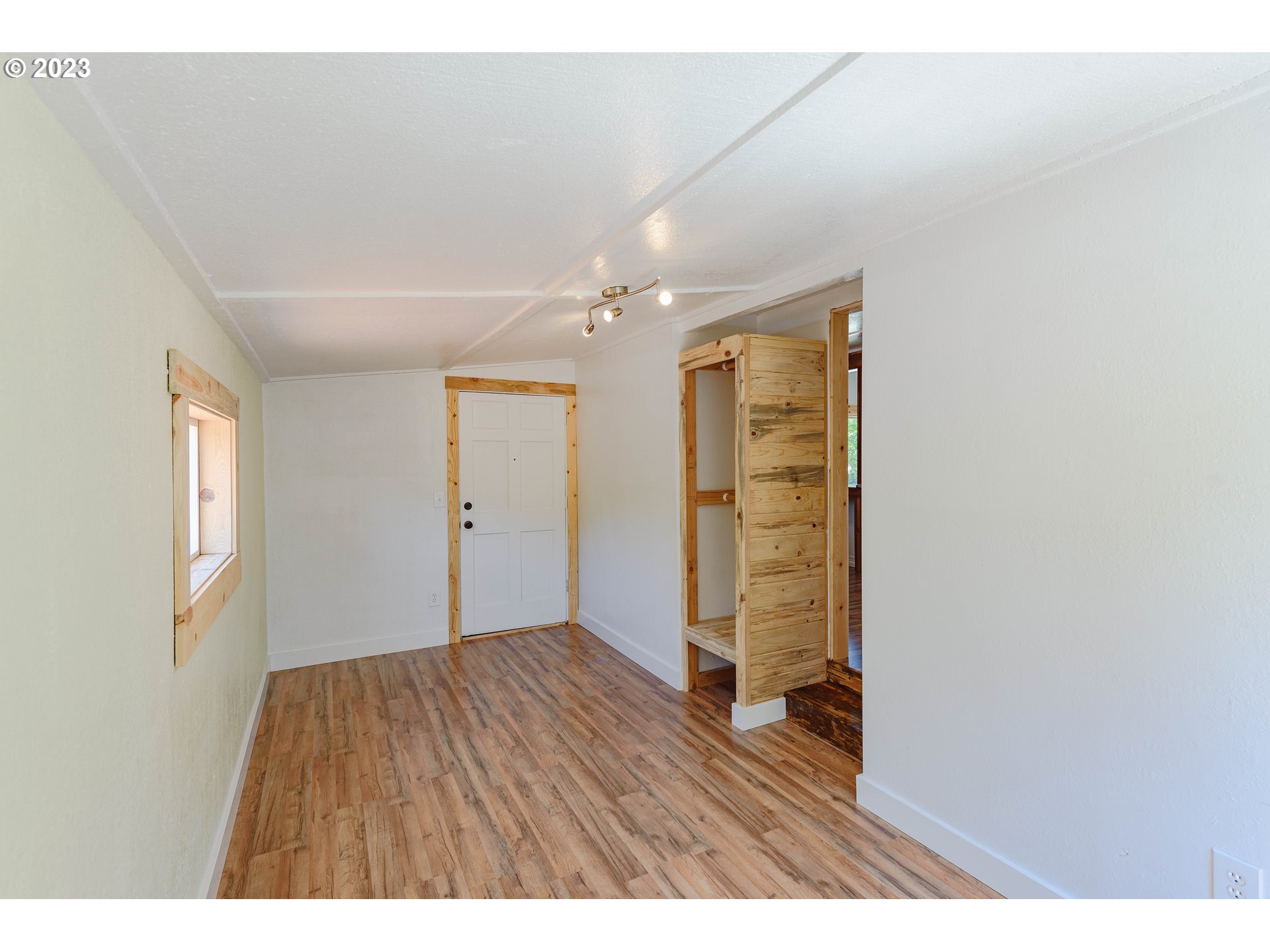 54156 Old Broadbent Road Myrtle Point, OR 97458 - Photo 7 of 48 a view of an empty room with wooden floor and a window