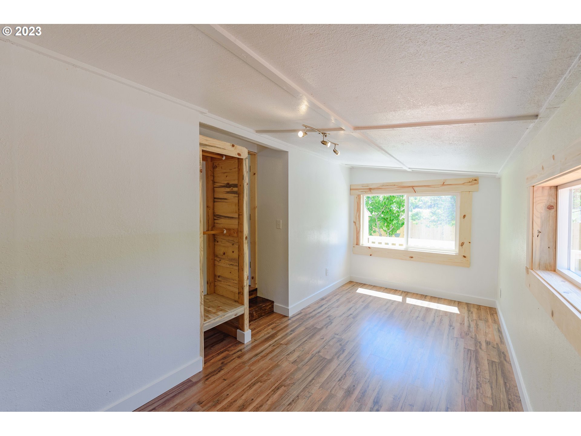 54156 Old Broadbent Road Myrtle Point, OR 97458 - Photo 9 of 48 a view of an empty room with window and wooden floor