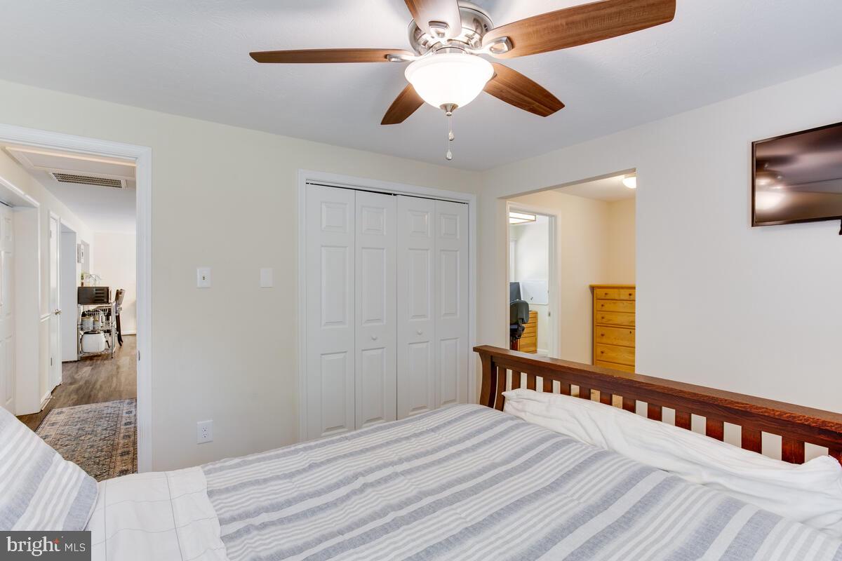 1260 Coster Road Lusby, MD 20657 - Photo 29 of 46 a view of a hallway with wooden floor and chandelier
