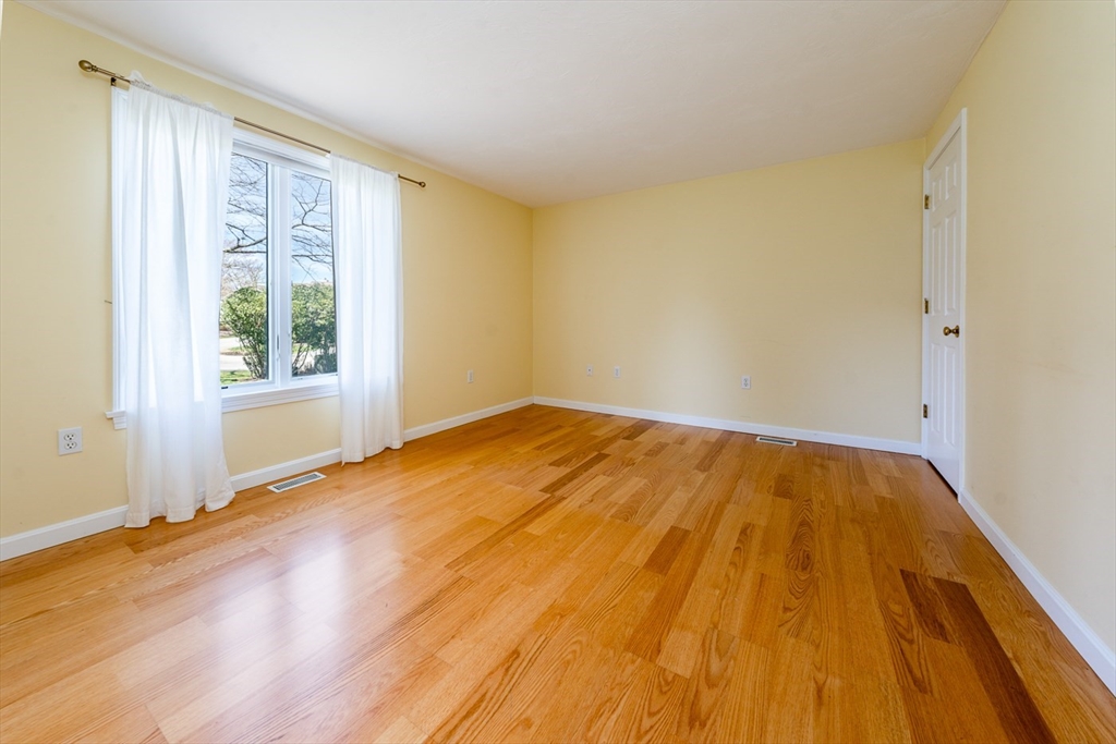 15 Beacon Court, Unit 229 Mashpee, MA 02649 - Photo 13 of 33 a view of empty room with wooden floor and fan