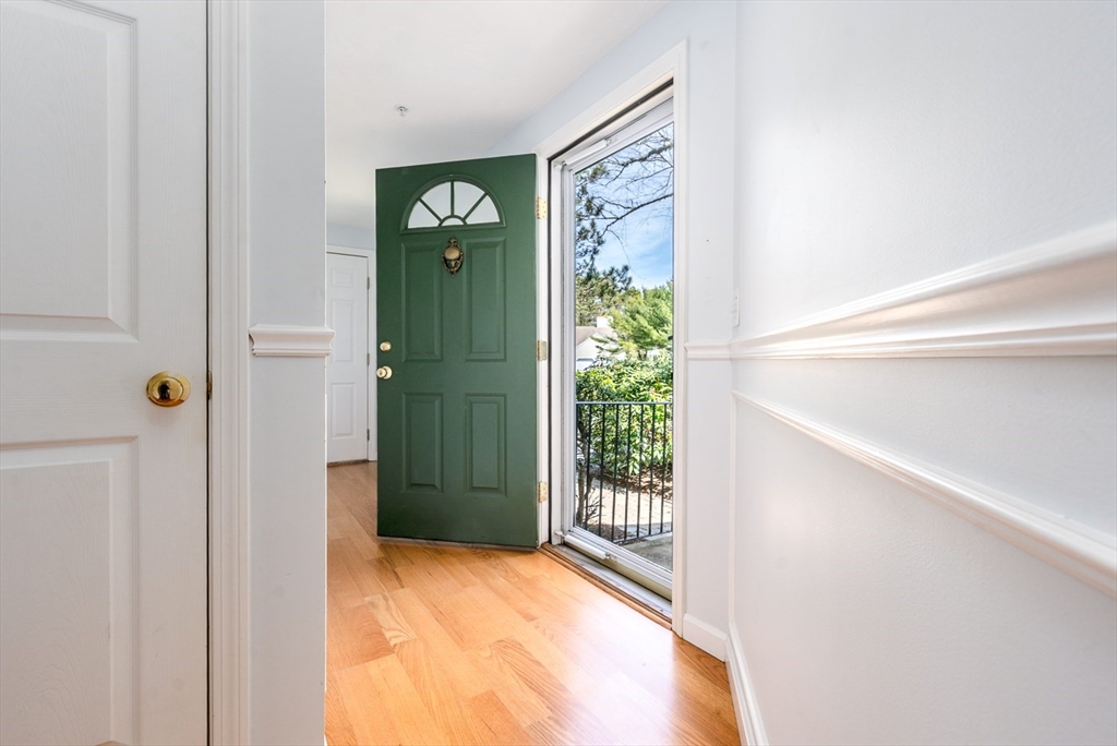 15 Beacon Court, Unit 229 Mashpee, MA 02649 - Photo 15 of 33 a view of a hallway with wooden floor and a living room