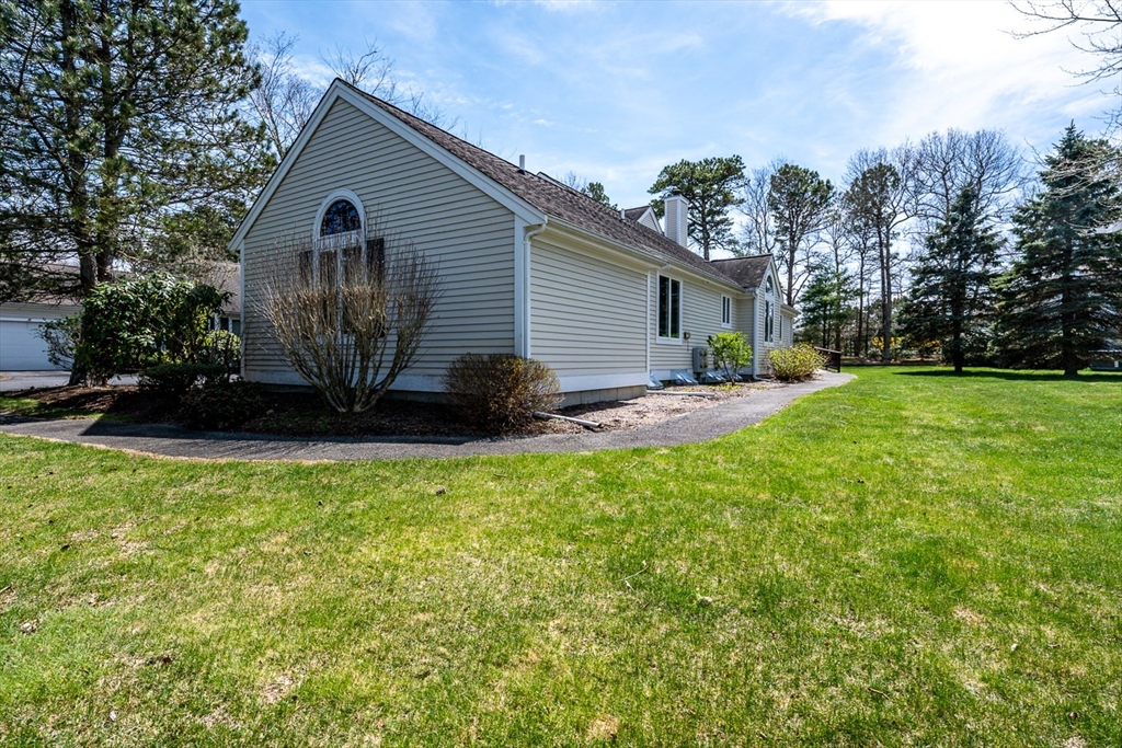 15 Beacon Court, Unit 229 Mashpee, MA 02649 - Photo 16 of 33 a front view of a house with garden