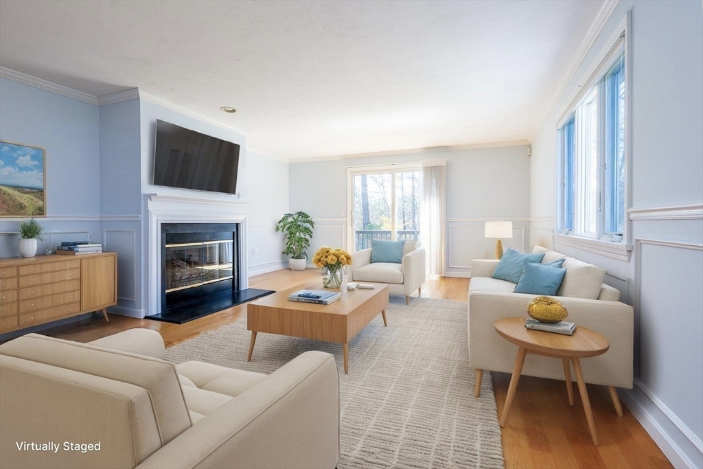 15 Beacon Court, Unit 229 Mashpee, MA 02649 - Photo 8 of 33 a living room with furniture a fireplace a flat screen tv and a large window