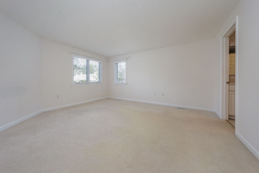 15 Beacon Court, Unit 229 Mashpee, MA 02649 - Photo 10 of 33 an empty room with windows